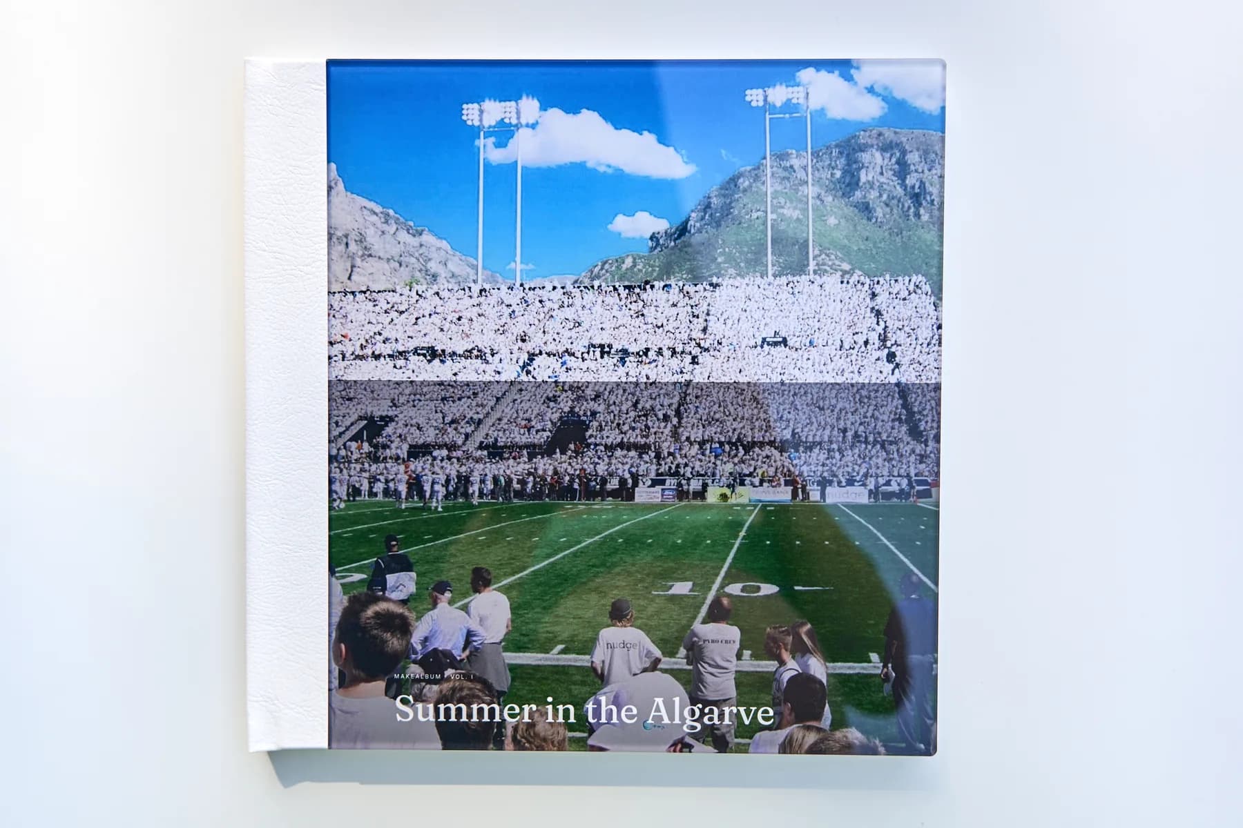 The front cover of a MakeAlbum book: an acrylic plate over the photograph and the title, a white leatherette spine