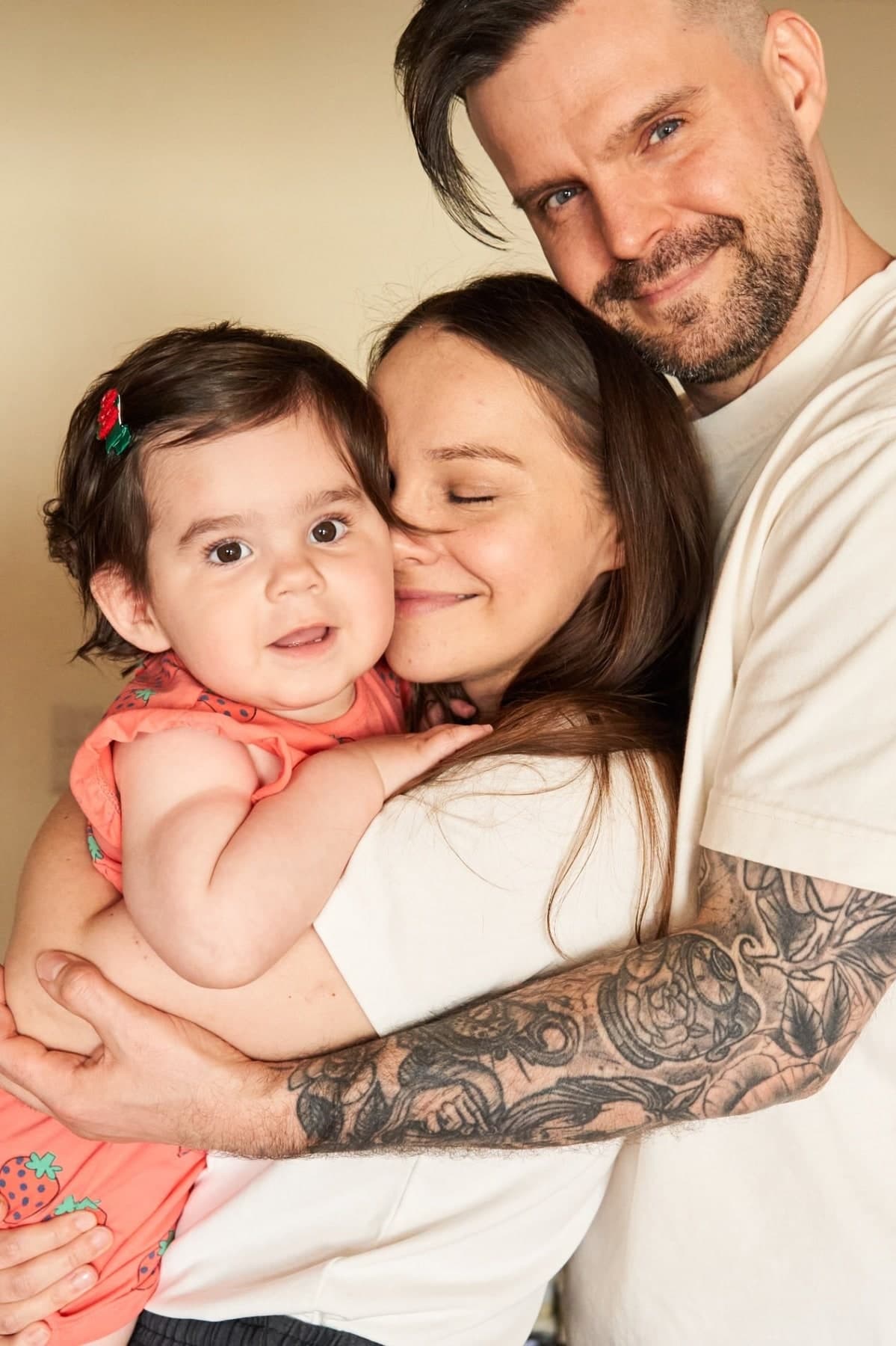 Studio portrait of a couple holding a toddler
